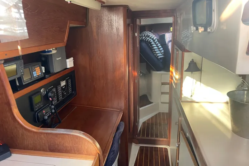 Slide: The Image of Interior of 1987 Irwin 38 Mk II sailboat with navigation equipment and wooden finish. - 29