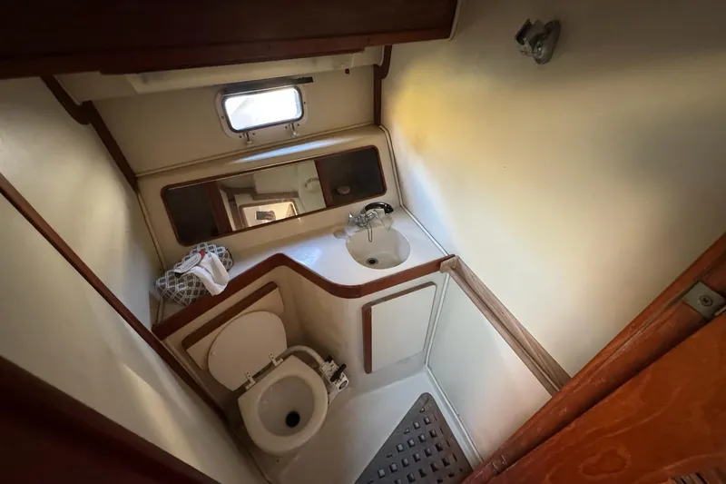Slide: The Image of 1987 Irwin 38 Mk II yacht bathroom with sink, toilet, and mirror. - 33