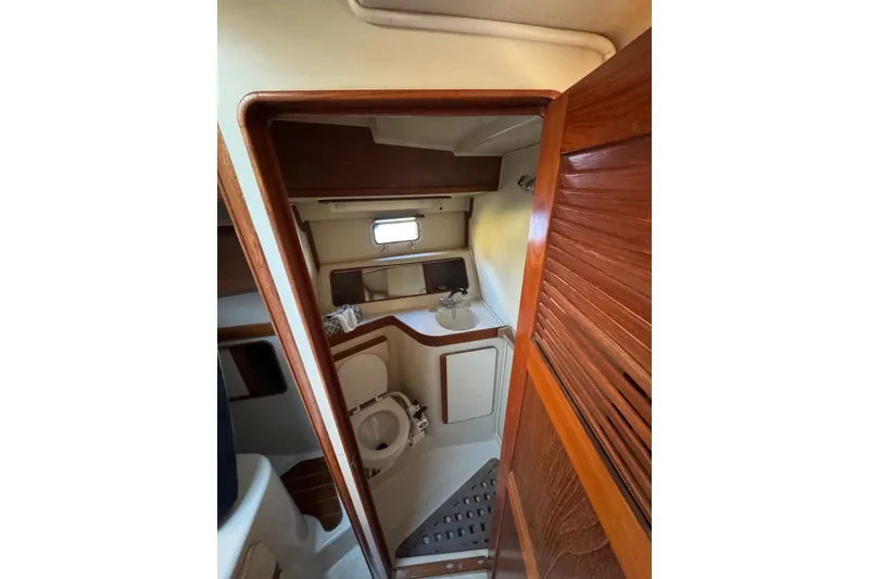 Slide: The Image of 1987 Irwin 38 Mk II yacht bathroom with wooden accents and compact design. - 34