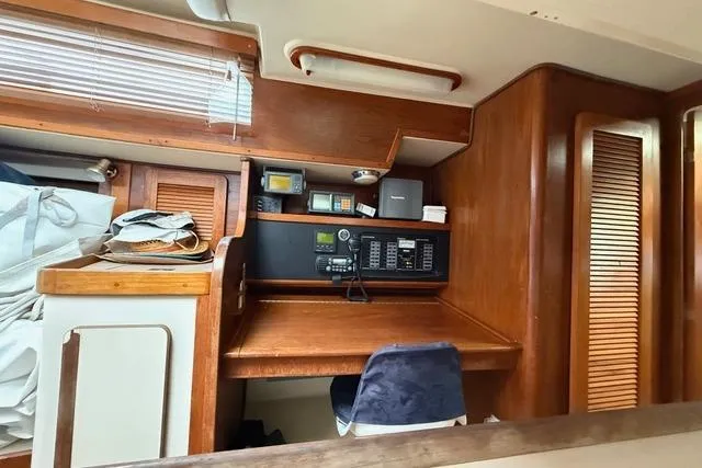 Slide: The Image of 1987 Irwin 38 Mk II yacht interior with navigation equipment and wooden cabinetry. - 35