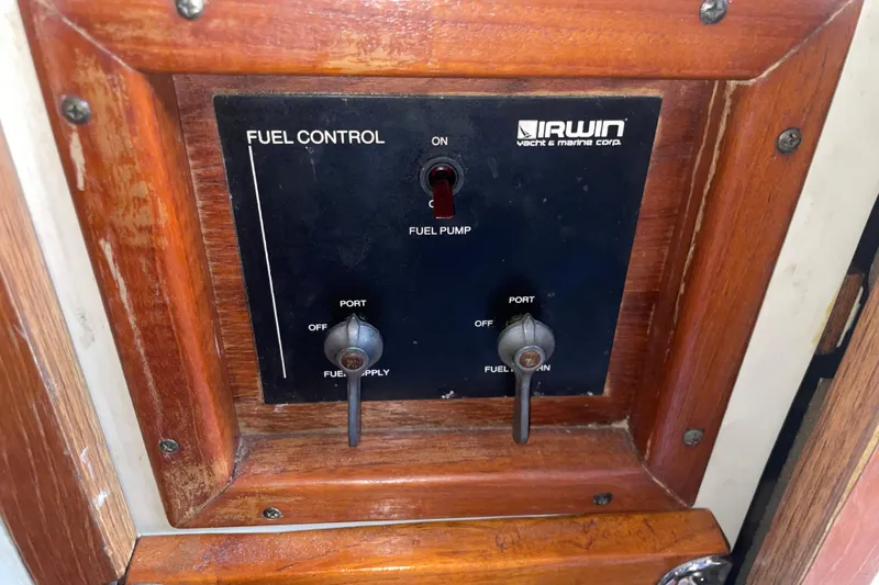 Slide: The Image of Fuel control panel of 1987 Irwin 38 Mk II yacht with wooden frame. - 38