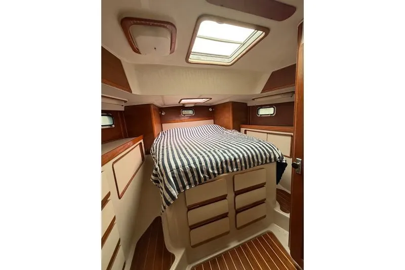 Slide: The Image of Cozy cabin interior of 1987 Irwin 38 Mk II sailboat with striped bedding. - 41