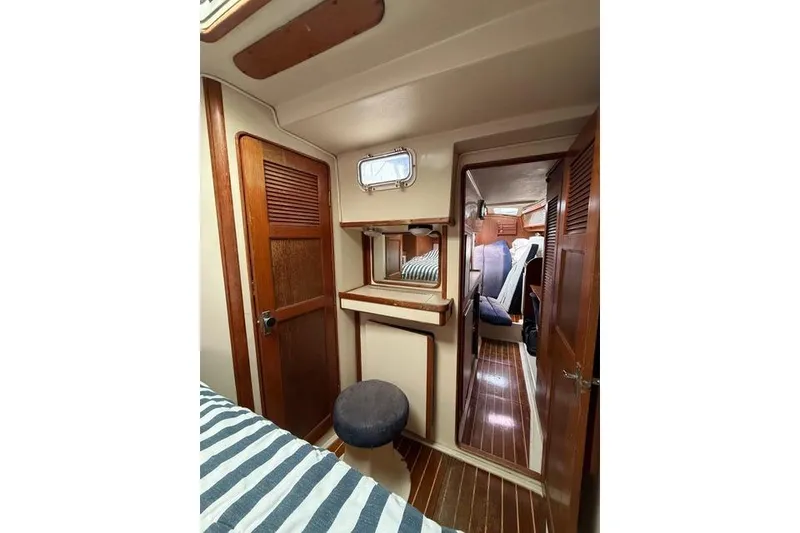 Slide: The Image of Interior of 1987 Irwin 38 Mk II sailboat with wooden finishes and cozy cabin space. - 44
