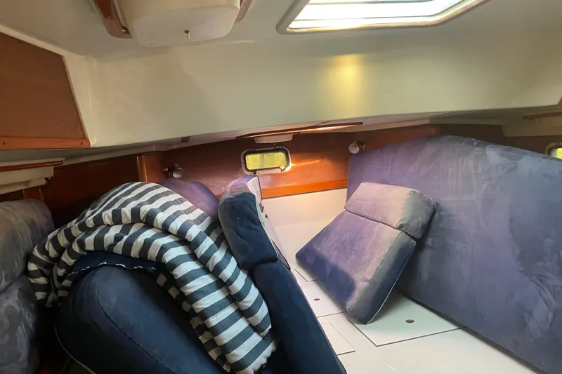 Slide: The Image of Interior cabin of 1987 Irwin 38 Mk II sailboat with blue cushions and striped blanket. - 45