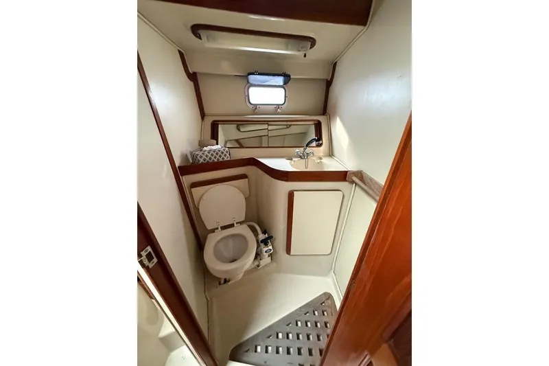 Slide: The Image of 1987 Irwin 38 Mk II yacht bathroom with toilet, sink, and window. - 49