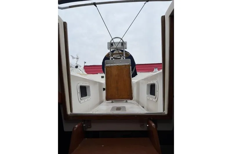 Slide: The Image of 1987 Irwin 38 Mk II sailboat cockpit view with wooden hatch and steering wheel. - 50