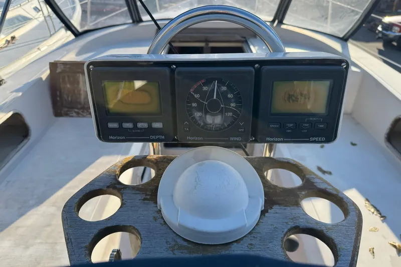 Slide: The Image of Cockpit of 1987 Irwin 38 Mk II sailboat with navigation instruments and steering wheel. - 6