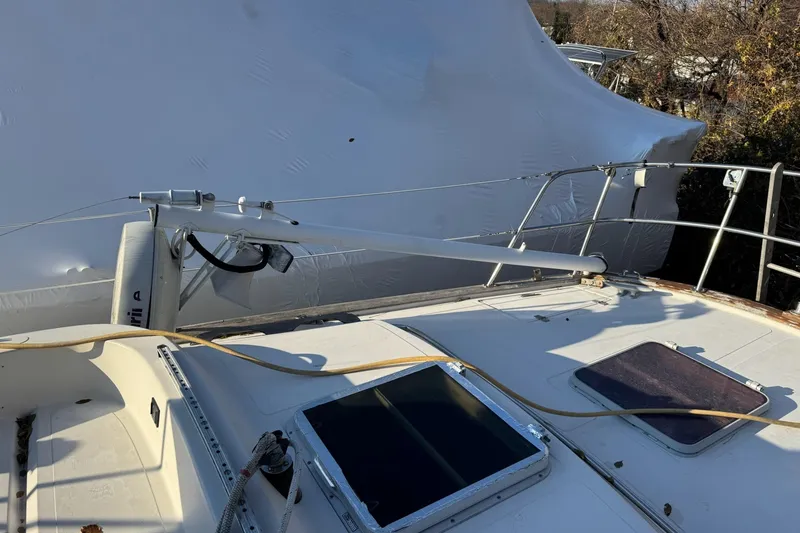 Slide: The Image of 1987 Irwin 38 Mk II sailboat deck with winch and railing, partially covered. - 9