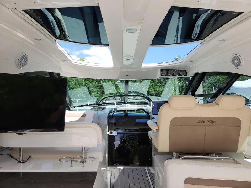 Slide: The Image of Interior of 2014 Sea Ray 470 Sundancer yacht with luxurious seating and modern dashboard. - 23
