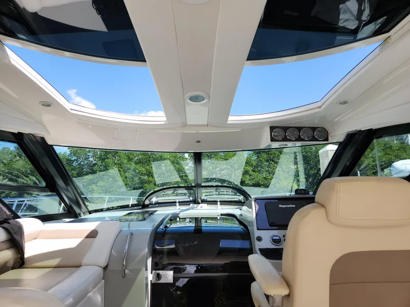 Slide: The Image of Interior view of 2014 Sea Ray 470 Sundancer yacht cockpit with panoramic windows. - 24