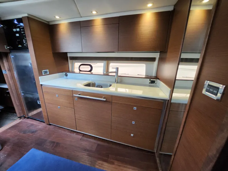 Slide: The Image of Luxurious kitchen interior of 2014 Sea Ray 470 Sundancer yacht with modern cabinetry. - 39