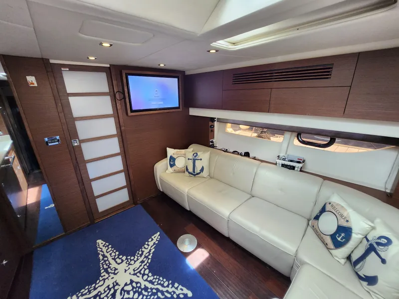Slide: The Image of Luxurious interior of 2014 Sea Ray 470 Sundancer yacht with white leather seating and nautical decor. - 43