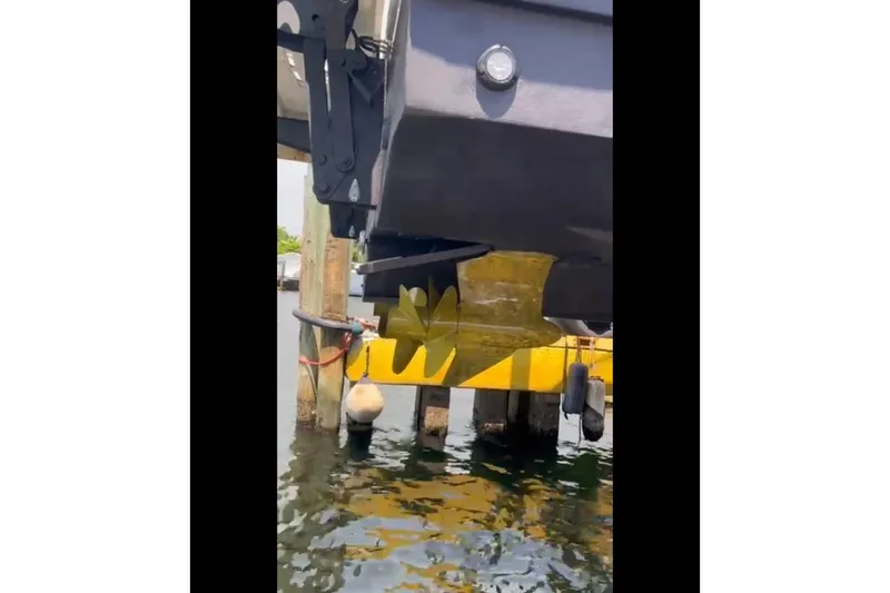 Slide: The Image of 2014 Sea Ray 470 Sundancer boat docked, showing hull and water reflection. - 68
