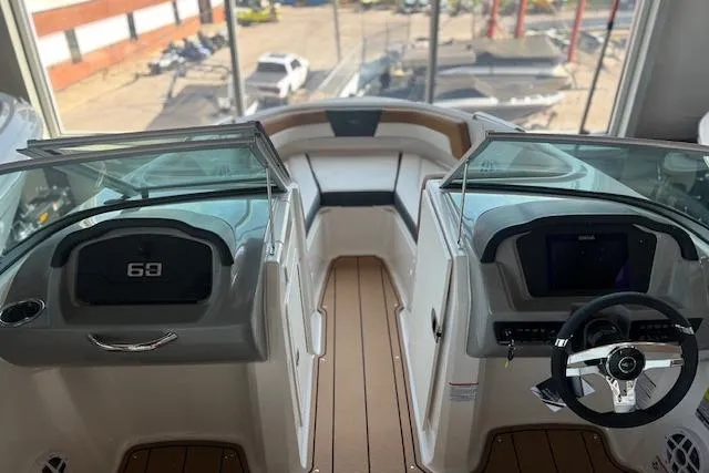 Slide: The Image of 2025 Chaparral 21 SSi boat interior with dual consoles and modern dashboard design. - 10