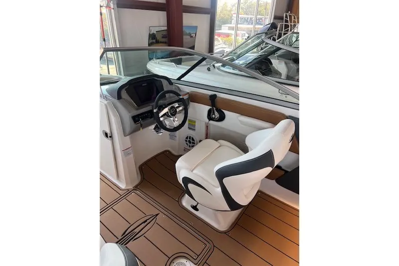 Slide: The Image of 2025 Chaparral 21 SSi boat interior with steering wheel and captain's seat. - 12