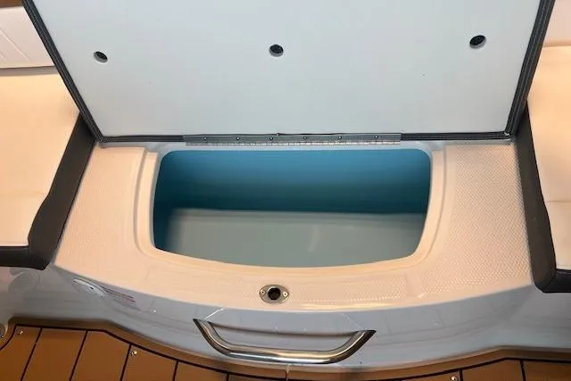 Slide: The Image of Open storage compartment on 2025 Chaparral 21 SSi boat, featuring sleek design and spacious interior. - 15