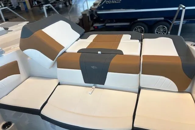 Slide: The Image of 2025 Chaparral 21 SSi boat interior with stylish brown and white seating. - 18