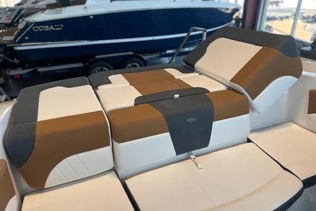 Slide: The Image of 2025 Chaparral 21 SSi boat interior with brown and white cushioned seating. - 19