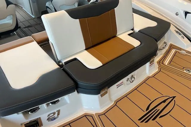 Slide: The Image of 2025 Chaparral 21 SSi boat interior with stylish seating and logo on deck. - 22