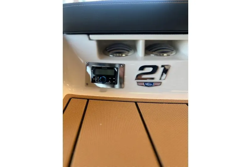 Slide: The Image of 2025 Chaparral 21 SSi boat interior with audio system and logo detail. - 23