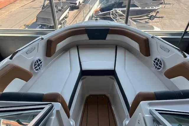 Slide: The Image of 2025 Chaparral 21 SSi boat interior with brown and white seating, modern design. - 5