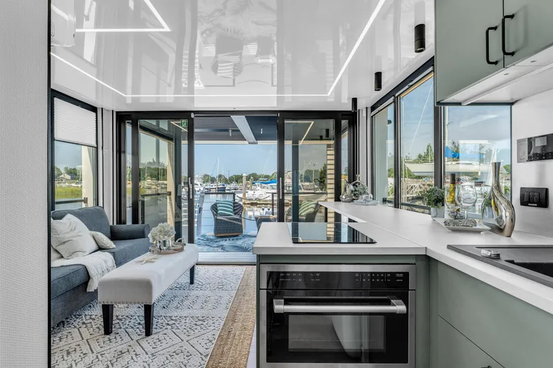 Slide: The Image of Modern Waterlodge 11 interior with sleek kitchen, cozy seating, and marina view, 2025 model. - 13