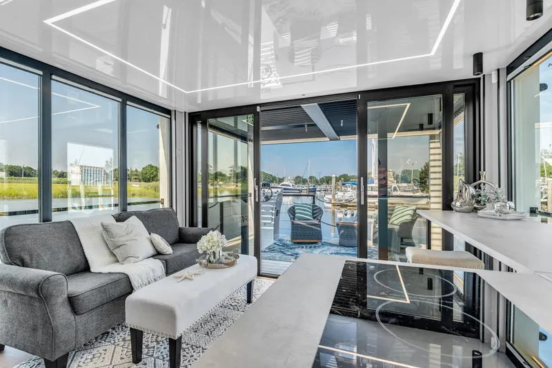 Slide: The Image of Modern Waterlodge 11 interior with sleek design, large windows, and scenic marina view, 2025 model. - 14
