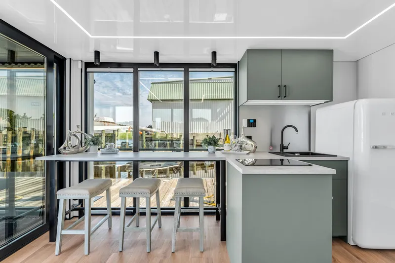 Slide: The Image of Modern Waterlodge 11 kitchen with sleek design, large windows, and contemporary furnishings, 2025 model. - 16