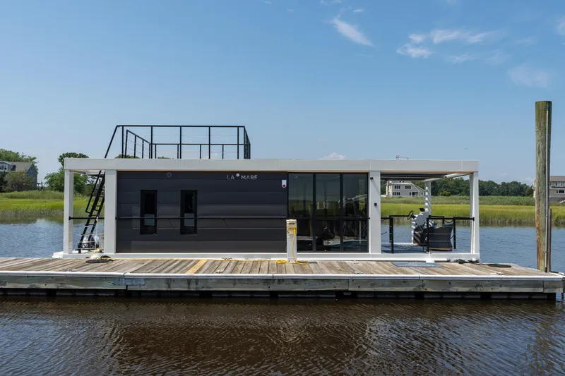 Slide: The Image of Modern Waterlodge 11 houseboat docked on a sunny day, featuring sleek design and rooftop access. - 25
