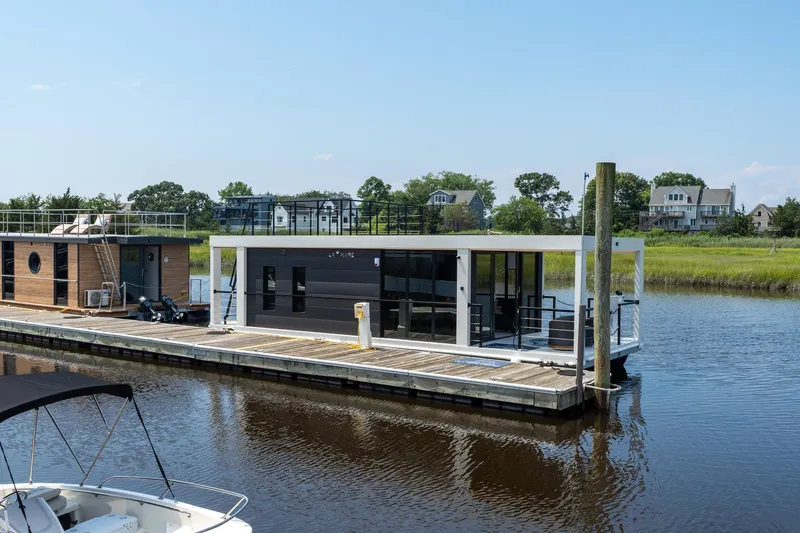 Slide: The Image of Modern Waterlodge 11 houseboat docked on a serene river, surrounded by lush greenery, 2025 model. - 26