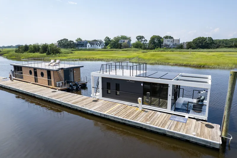 Slide: The Image of Modern Waterlodge 11 houseboat docked on a serene river, surrounded by lush greenery. - 27