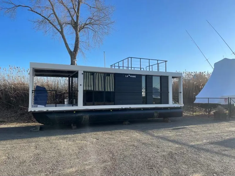 Slide: The Image of Modern 2025 Waterlodge houseboat, sleek design, docked on a sunny day. - 32