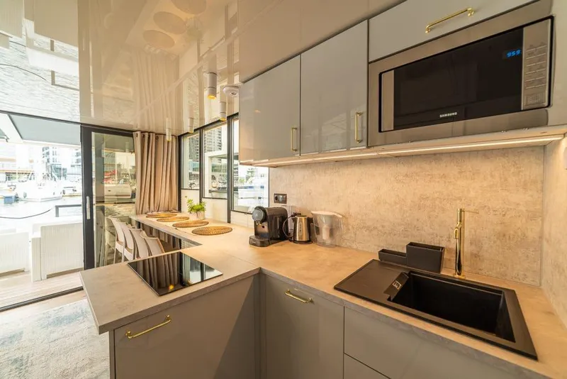 Slide: The Image of Modern kitchen interior in Waterlodge Modern 11 houseboat, featuring sleek appliances and waterfront view. - 35