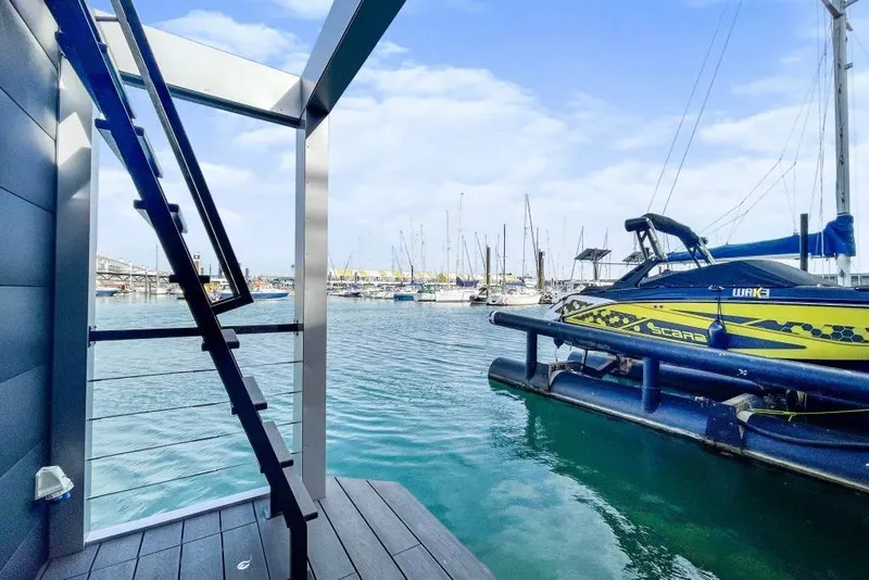 Slide: The Image of Modern Waterlodge 11 houseboat with marina view, featuring sleek design and vibrant jet ski, 2026 model. - 41