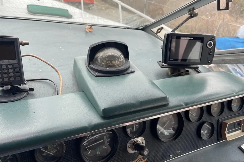 Slide: The Image of Control panel of a 1988 Sea Ray 300 Weekender boat with gauges and throttle levers. - 12