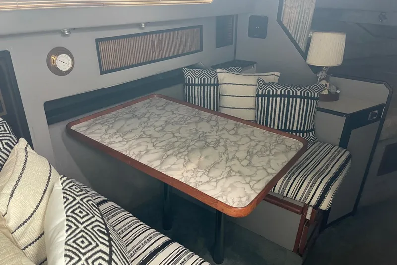 Slide: The Image of Interior of 1988 Sea Ray 300 Weekender boat with kitchenette and welcome sign. - 21