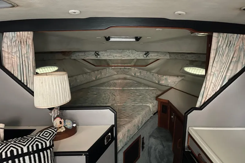 Slide: The Image of Interior of 1988 Sea Ray 300 Weekender with striped cushions and marble-patterned table. - 24