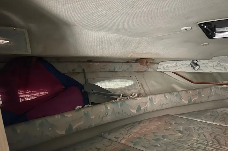 Slide: The Image of Interior cabin of 1988 Sea Ray 300 Weekender boat with patterned upholstery and wooden accents. - 26