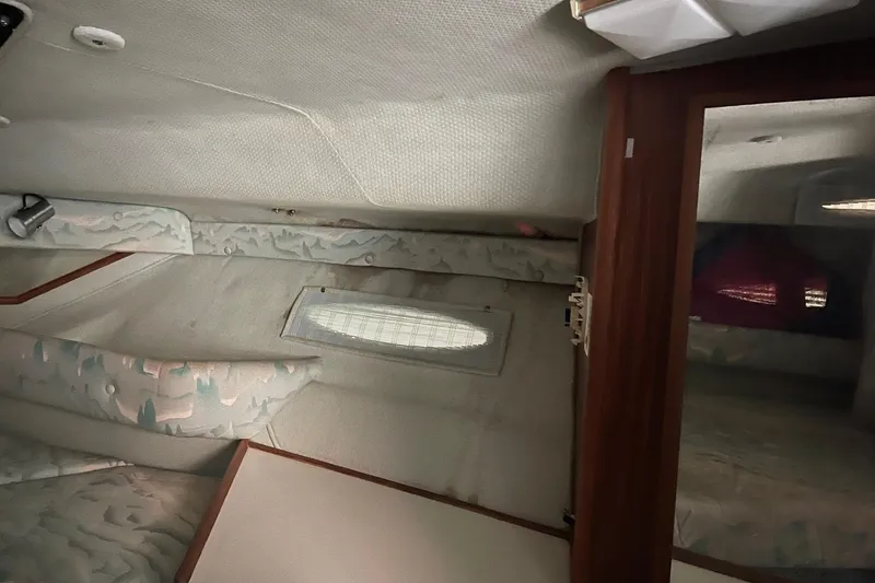 Slide: The Image of Interior cabin of 1988 Sea Ray 300 Weekender with pink and blue fabric. - 27