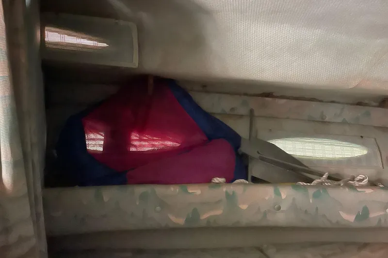 Slide: The Image of Interior of 1988 Sea Ray 300 Weekender with striped seating and marble table. - 28