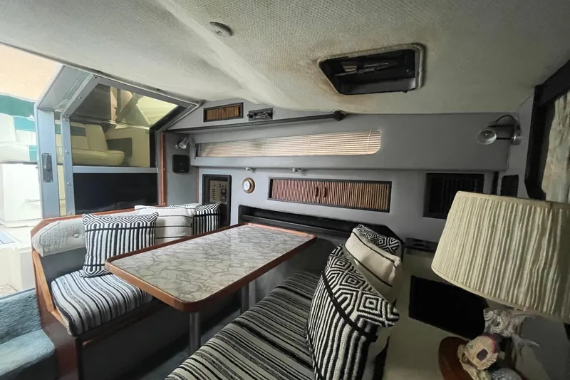 Slide: The Image of 1988 Sea Ray 300 Weekender interior kitchen with sink, countertop, and storage cabinets. - 29