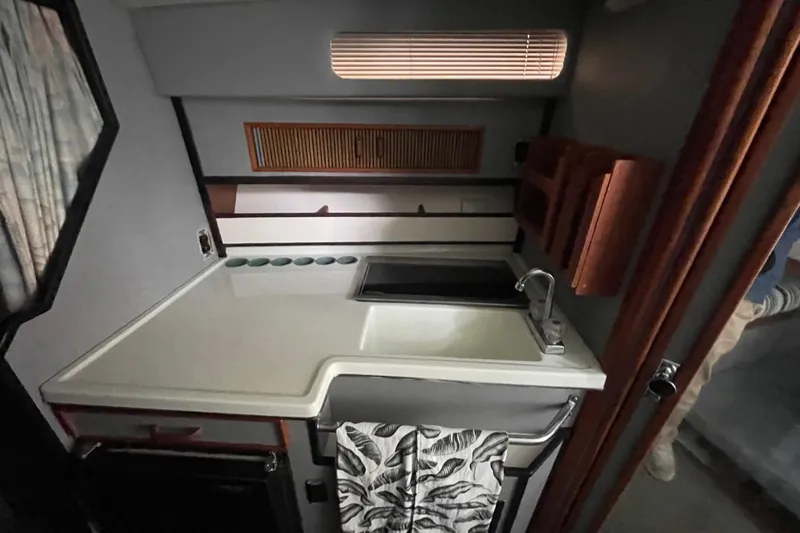 Slide: The Image of 1988 Sea Ray 300 Weekender boat bathroom with toilet and sink. - 30
