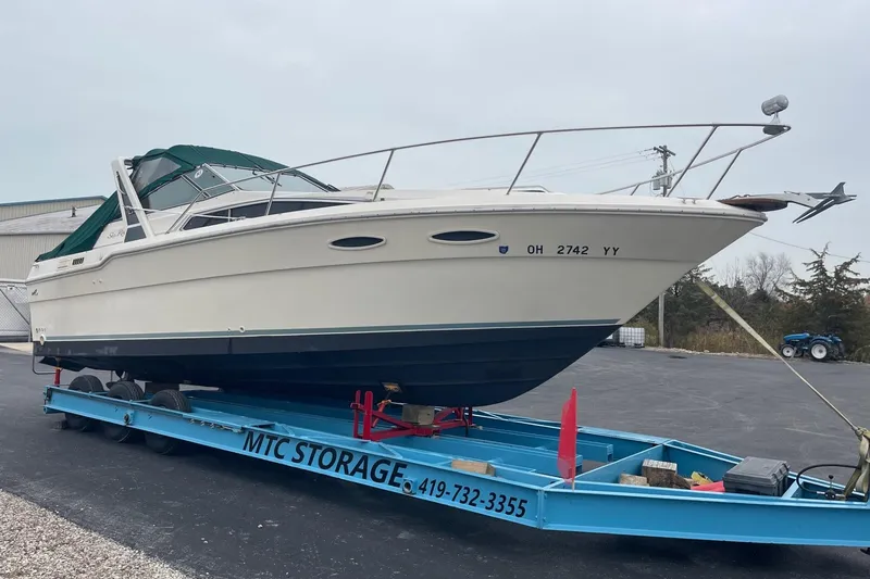 Slide: The Image of Interior of 1988 Sea Ray 300 Weekender boat with green and white seating. - 5