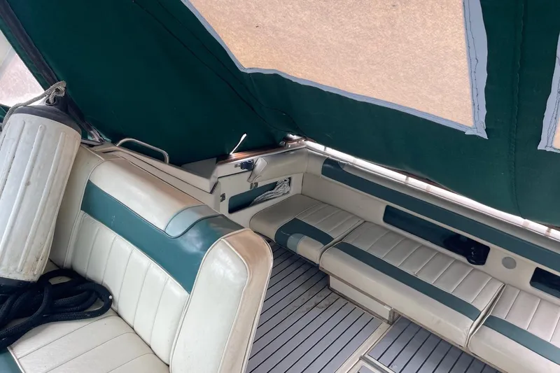 Slide: The Image of 1988 Sea Ray 300 Weekender interior with green canopy and white seating. - 6
