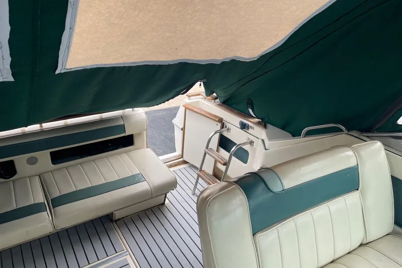 Slide: The Image of 1988 Sea Ray 300 Weekender interior with white and teal seating, showcasing classic design. - 7