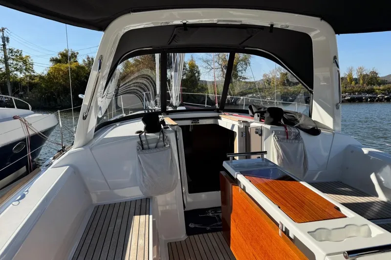 Slide: The Image of 2023 Beneteau Oceanis 38.1 yacht cockpit with sleek design and wooden accents. - 6