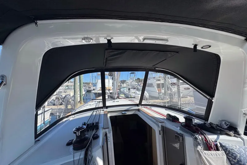 Slide: The Image of Interior view of 2023 Beneteau Oceanis 38.1 sailboat cockpit with marina background. - 7