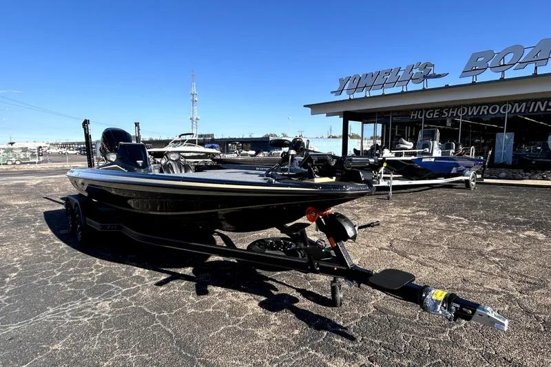 Slide: The Image of 2026 Skeeter ZXE21 boat displayed outside showroom on a sunny day. - 1