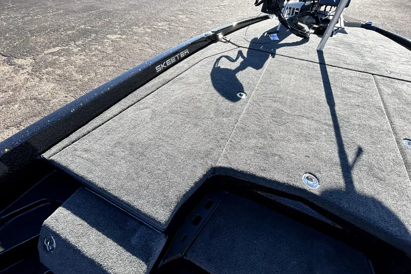 Slide: The Image of 2026 Skeeter ZXE21 boat deck with carpeted surface and visible shadow. - 11