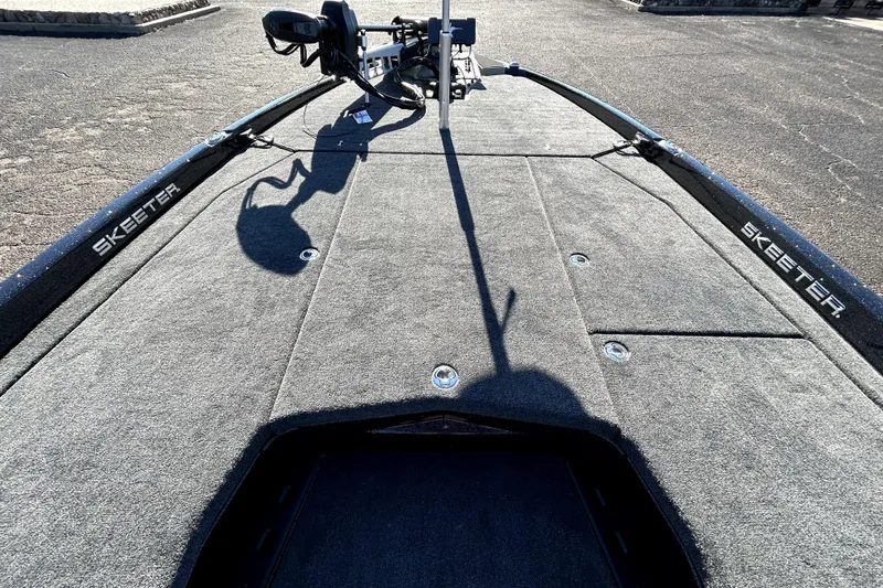 Slide: The Image of 2026 Skeeter ZXE21 boat deck with carpeted surface and storage compartments. - 13